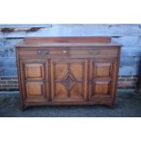 A James Shoolbred walnut sideboard, fitted two drawers over cupboards enclosed panelled doors, 57"