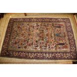 A Persian part silk pile tree and vase design rug on a light ground and multi-bordered in shades