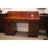 A 19th century mahogany ledge back double pedestal sideboard, fitted three drawers over cupboards,