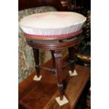 A 19th century carved walnut piano stool with adjustable seats, on three square taper supports, a