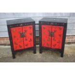 A pair of red lacquered and black butterfly decorated side cupboards, 22 1/2" wide x 14 1/2" deep