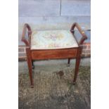 A walnut and line inlaid box seat piano stool with needlework seat, 22" wide, and a similar oval