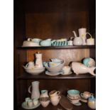 A collection of Poole "Cameo" pattern table wares, including vases, part teaset, shells, platters,
