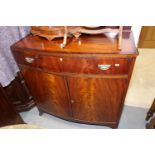 A mahogany and satinwood bowfront side cupboard, fitted two drawers over two doors, on splay