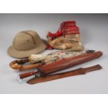 Two Japanese lacquered paper parasols, another similar, a leather fly whisk, a pith hat, fur boots