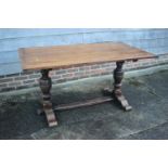 An oak refectory table, on twin bulbous turned and stretchered supports, 56" long x 33" wide x 29