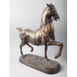 A patinated brass model of a stallion, 24" high