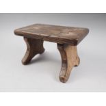 A 19th century chestnut stool, on panel end supports, 10 1/2" long x 6 " wide x 6 1/2" high