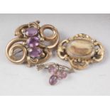 Two 19th century yellow metal and amethyst brooches and a yellow metal mourning brooch, 35.7g