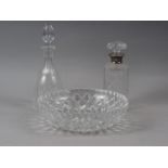 A heavy cut glass bowl, on scroll feet, 11" dia, a cut glass decanter with spearpoint stopper, and a