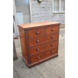 A mahogany chest of two short and three long drawers with knob handles, on turned supports, 42" wide