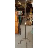 A wrought iron standard lamp, on tripod splay supports, 63 1/2" high