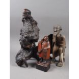 An Oriental carved rootwood figure of a mythical man, an African carved wood figure of an elderly