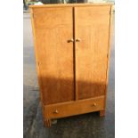 A light oak linen cupboard enclosed two doors over one long drawer, on stile supports, 30 1/2"