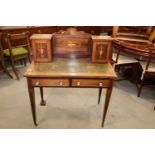 An Edwardian rosewood and inlaid writing desk, fitted two cupboards over two drawers, on square