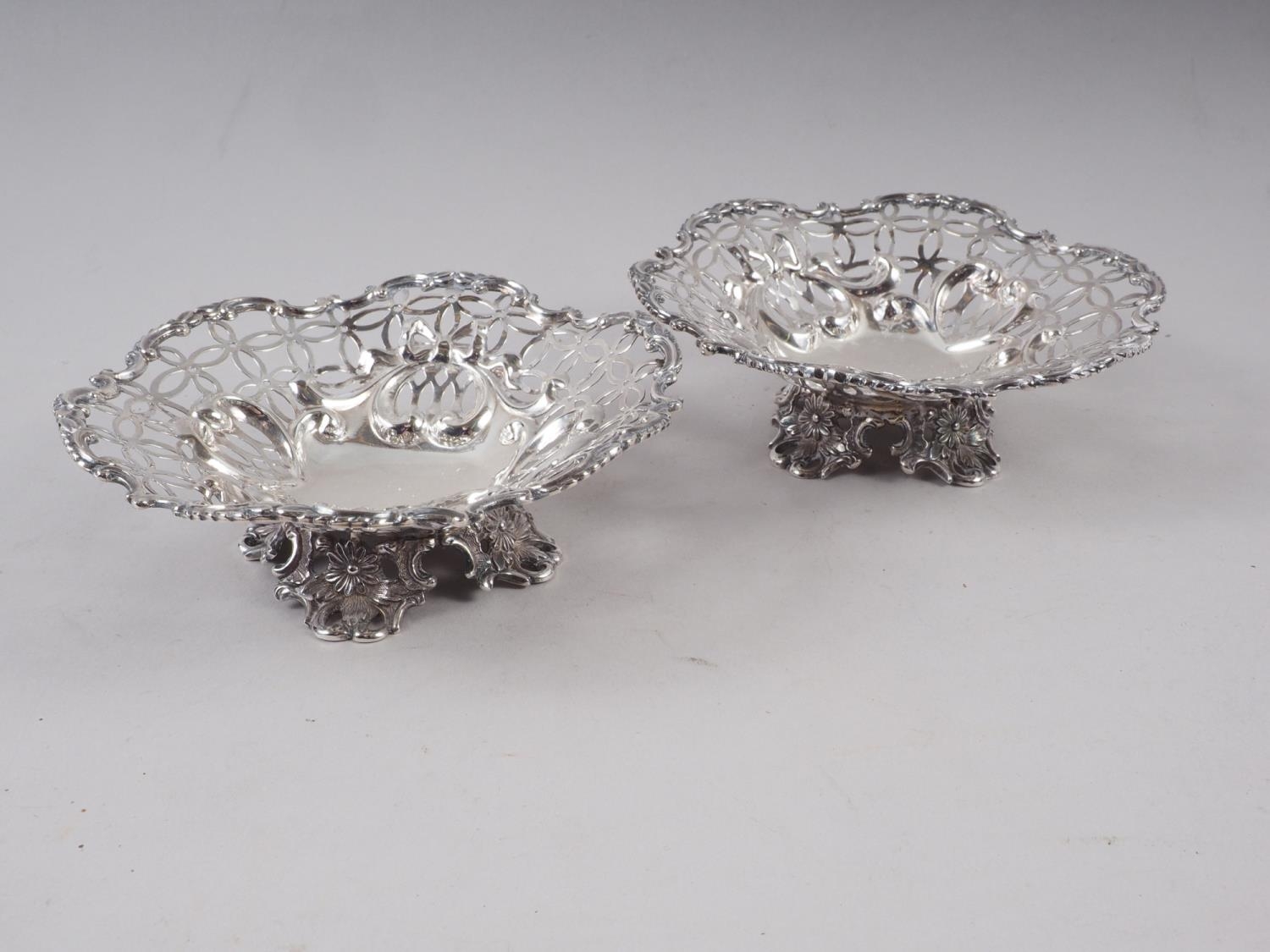 A pair of pierced silver bonbon dishes, on scroll feet, 6.5oz troy approx