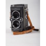 A Rollei Magic II twin lens reflex camera, supplied by Wallace Heaton & Co, in leather case
