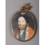 A late 17th century/early 18th century portrait miniature of a bearded gentleman in red jacket