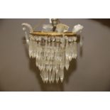 A three-tier chandelier with glass spear drop, 8" dia