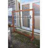 An early 20th century grained as oak coat rack with extra brass rail, 64" wide x 62" high