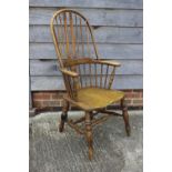 A modern Windsor elbow chair with panel seat, spindle and lath carved splat back, on turned and