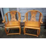 A pair of Chinese "Ming" style carved hardwood "thrones"/armchairs with panel seats and scroll