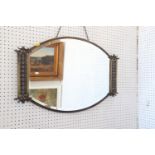 An Art Deco design anodised brass oval-shaped wall mirror with bevelled plate, 17 1/2" x 23 1/2",