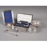A silver fork and spoon christening set, a similar fork and spoon, a silver topped toilet jar, a