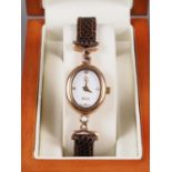 A lady's Clogau 9ct gold cased wristwatch with white dial and brown leather strap