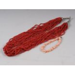 A twenty-strand necklace of 2.5mm coral beads and a modern stick coral bracelet