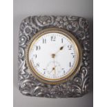 A silver mounted embossed and engraved desk clock with white enamel dial, marks Birmingham 1898