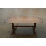 An Ercol elm shape top dining table, on panel end stretchered supports, 72" wide x 34" deep x 28 1/
