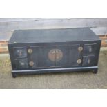 An "antique" Chinese black lacquered low side cupboard, fitted four small drawers and central