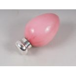A pink glass oviform scent bottle with silver mounts, 2 1/2" long overall