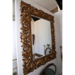 A Florentine carved giltwood open acanthus scrollwork framed wall mirror, 42" wide x 52" high