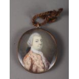 An 18th century portrait miniature of an unknown gentleman, in embroidered jacket, 3.8cm x 3.2cm, in