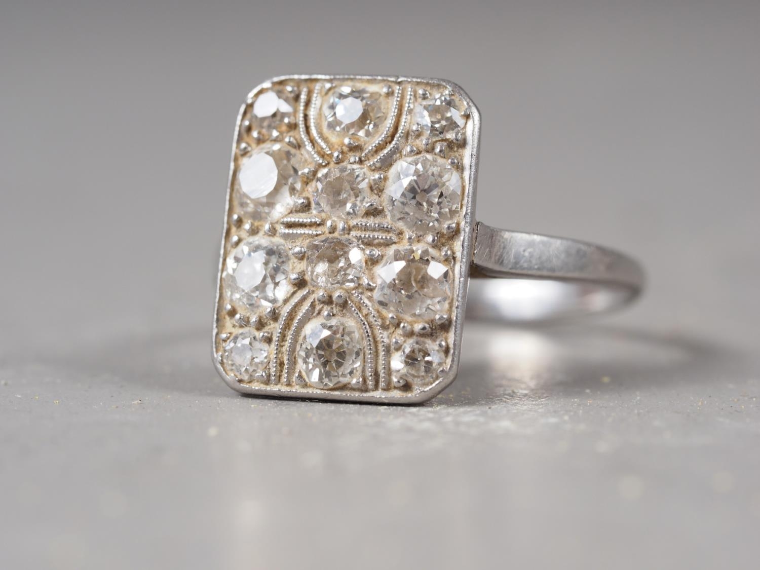 An Art Deco platinum and twelve-stone pave set diamond dress ring, 5.4g