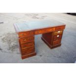 A late 19th century mahogany double pedestal desk with tooled lined top, fitted nine drawers with