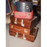 A leather vintage suitcase and a number of other suitcases, various