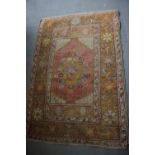 A Caucasian rug with central medallion on a red ground and multi-bordered in shades of yellow,