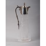 A cut glass claret jug with engraved vine design and silver mounts