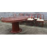 A Chinese hardwood circular dining table, fitted four frieze drawers, on faux bamboo cluster column,