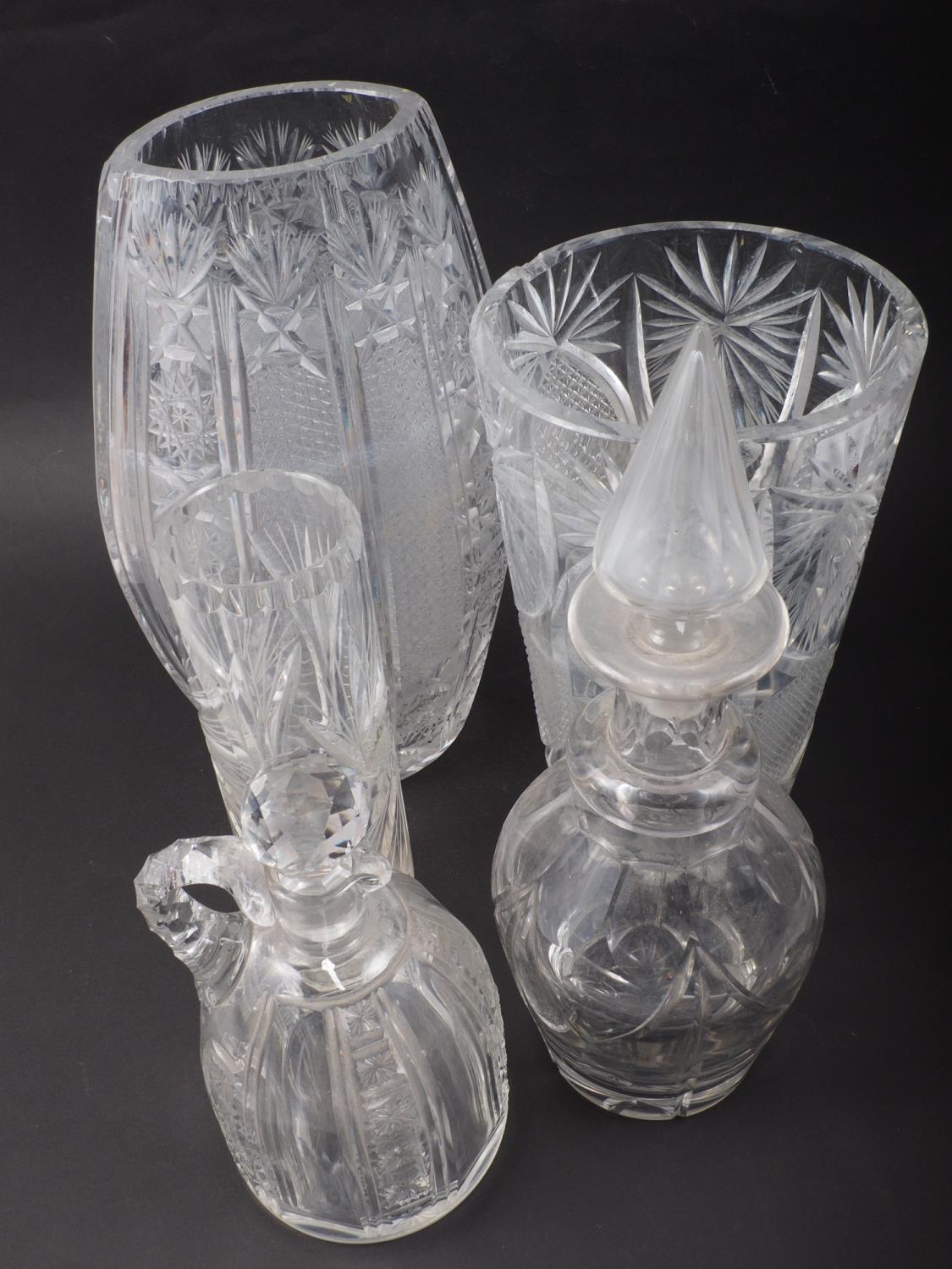 A 19th century cut glass decanter with spearpoint top, a cut glass liqueur decanter and stopper, and