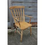 A beech Windsor lath back farmhouse elbow chair (damages)