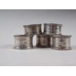 A pair of silver napkin rings and three other silver napkin rings, 4.8oz troy approx