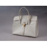 A white "crocodile" handbag by Baroni Italy with canvas dust cover