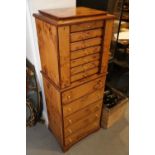 A burr yew wood jewellery armoire, by Agresti, the hinged top with mirror over eleven long graduated