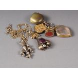 A yellow metal and rock crystal heart-shaped locket set amethyst, a gilt metal locket with cameo