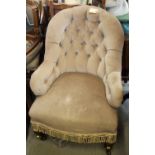 A late 19th century tub-shape armchair, button upholstered in a mushroom velour, on turned and