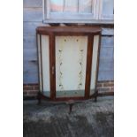 A 1950s walnut shape front display cabinet enclosed glazed panel door, on cabriole supports, 34"